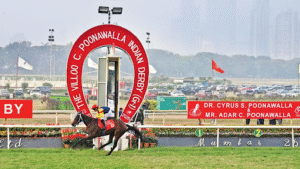 Thoroughbred horses racing at Mahalaxmi Racecourse during the ₹4 Crore Villoo C. Poonawalla Indian Derby with packed grandstands in the background.